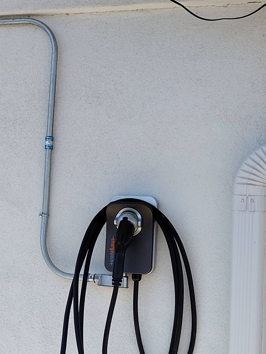 ChargePoint home charger fed by a neat surface conduit run