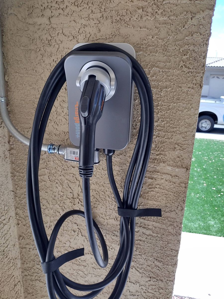 ChargePoint home charger mounted on a stucco exterior wall