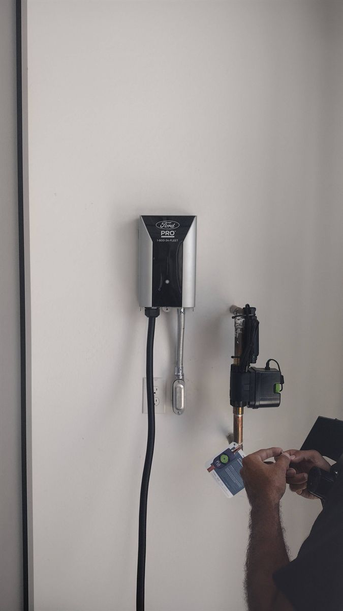 Hardwired Level 2 charger on a garage wall during installation