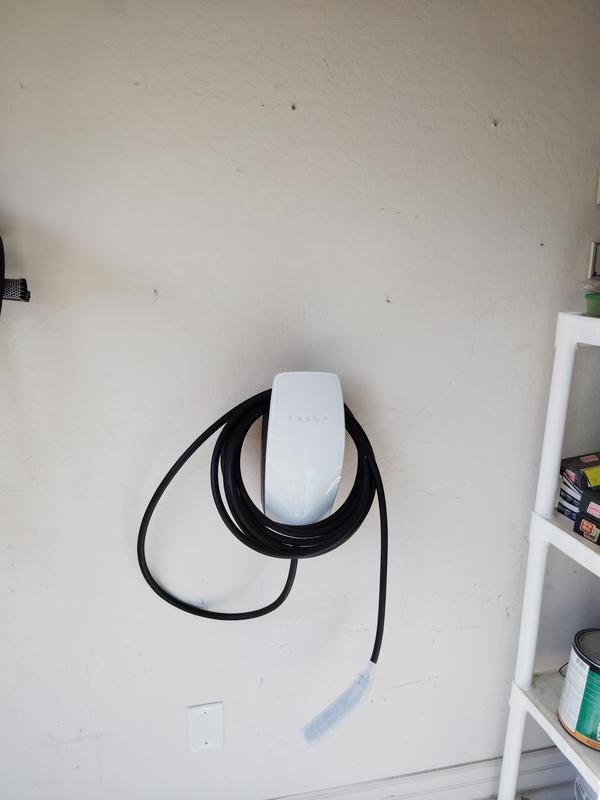 Tesla Wall Connector installed on a residential garage wall