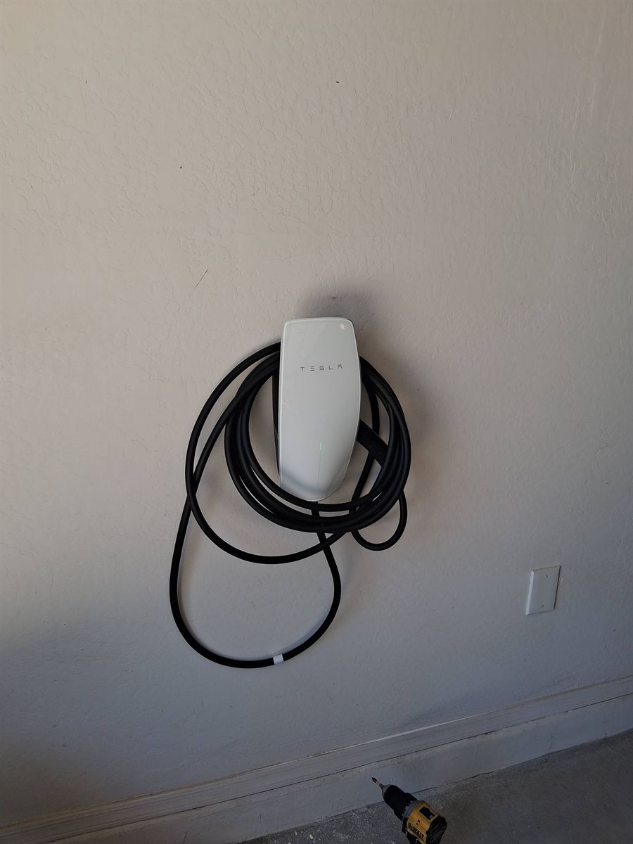 Tesla Wall Connector installed on a home garage wall